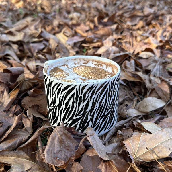 Earl Grey Hot Chocolate with Mandarin Whipped Cream on a bed of Autumn leaves